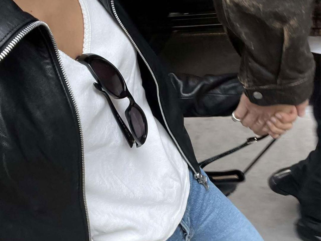 woman wearing white tshirt, leather jacket, and jeans