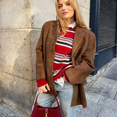 Sabina Socol in a red Reformation sweater and Gucci Jackie Bag