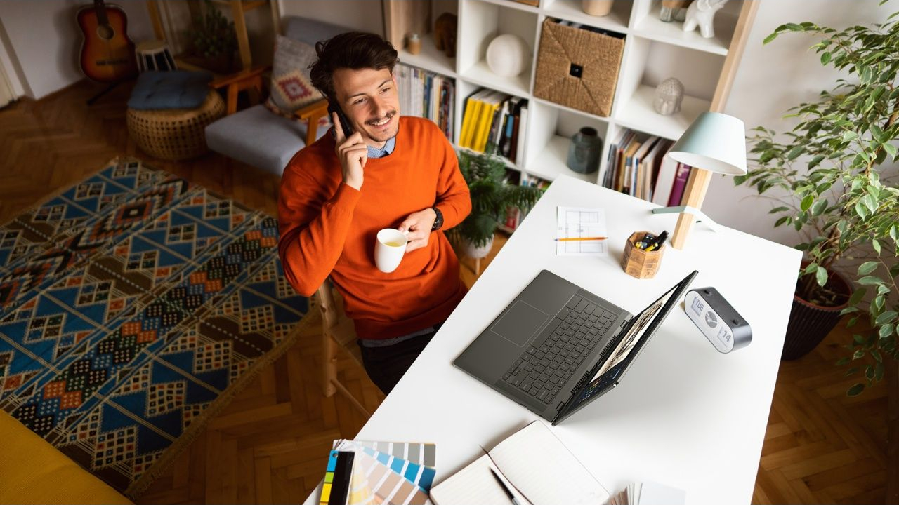 A man sitting in a home office with an Acer Chromebook Plus 514