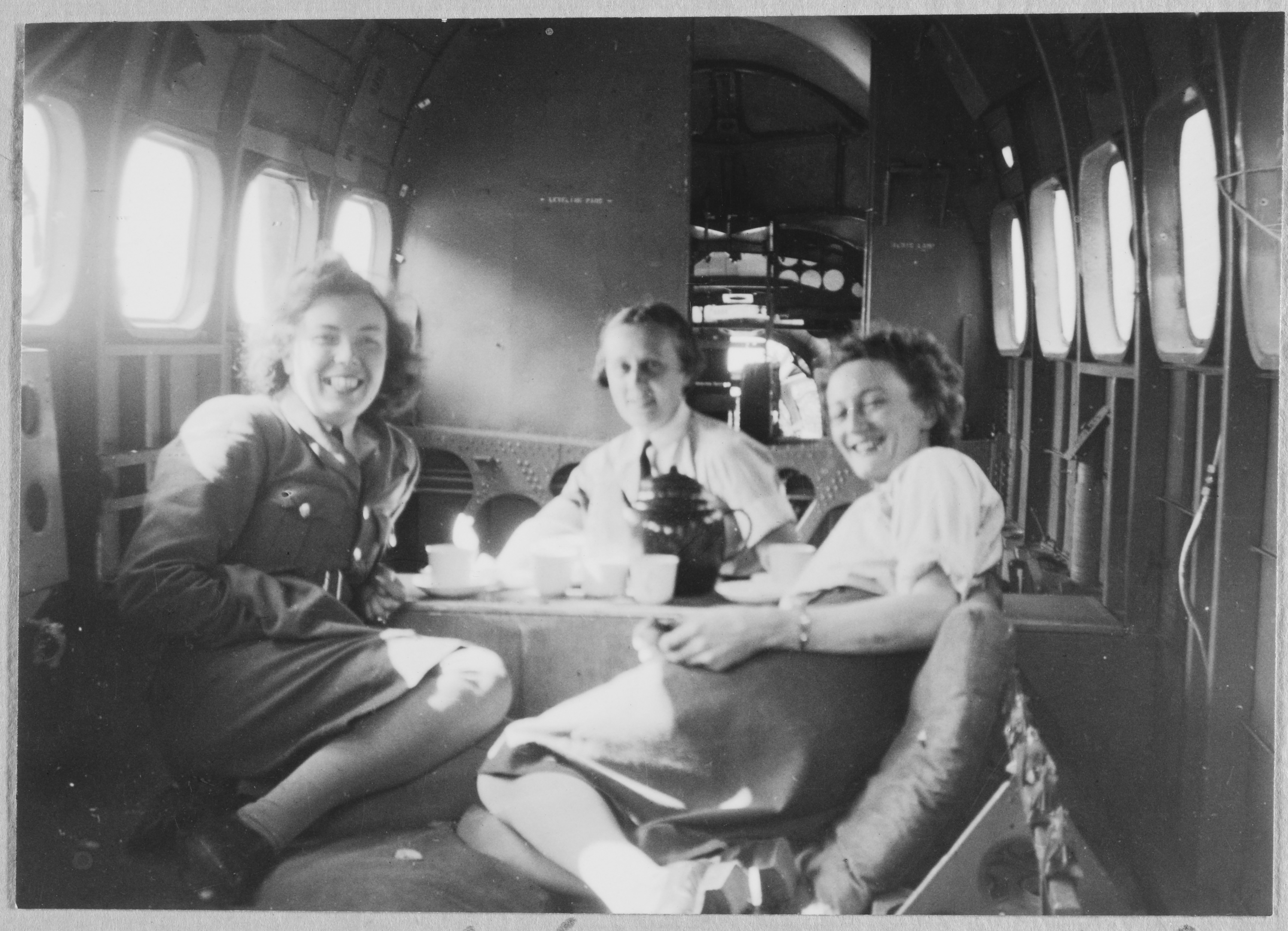 Three WAAF (Women's Auxiliary Air Force) officers having tea aboard an RAF aeroplane