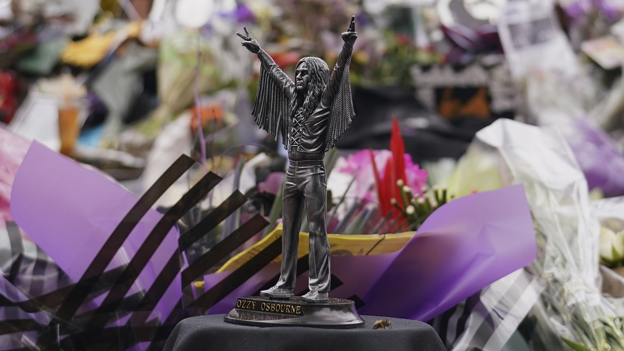 Tributes are seen during the funeral procession for Black Sabbath frontman Ozzy Osbourne in Birmingham, England