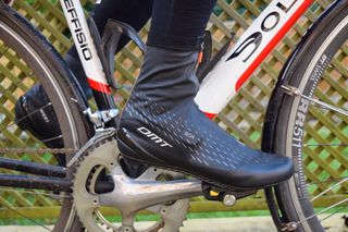 A cyclist wearing a pair of DMT WKR1 shoes