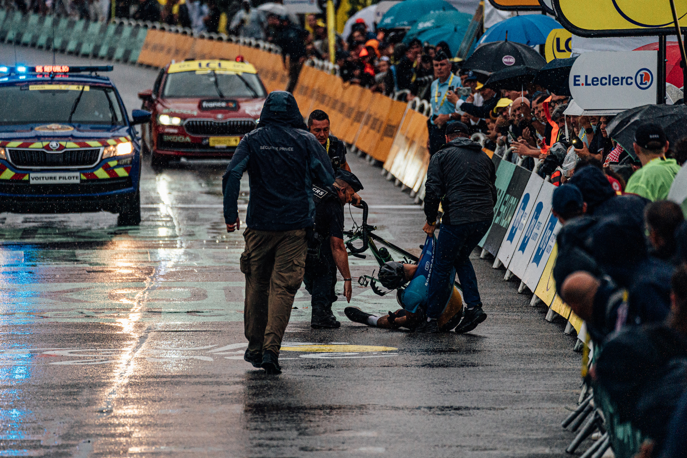 A protestor is tackled at the finish of stage 17 of the Tour de France