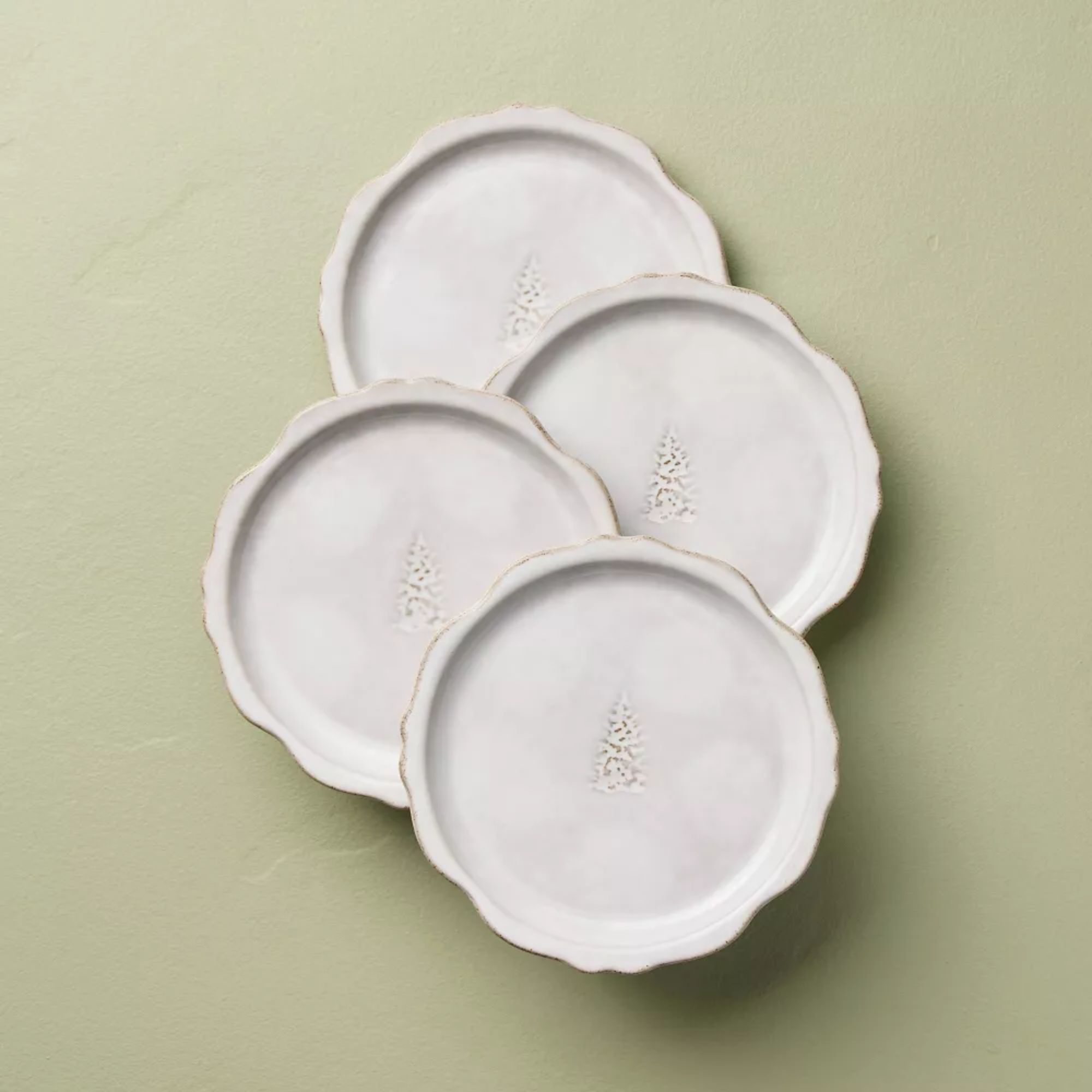 White scalloped plates with tree icon