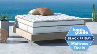 A Saatva mattress on a wodden bed with a Tom&#039;s Guide Black Friday mattress deal tag