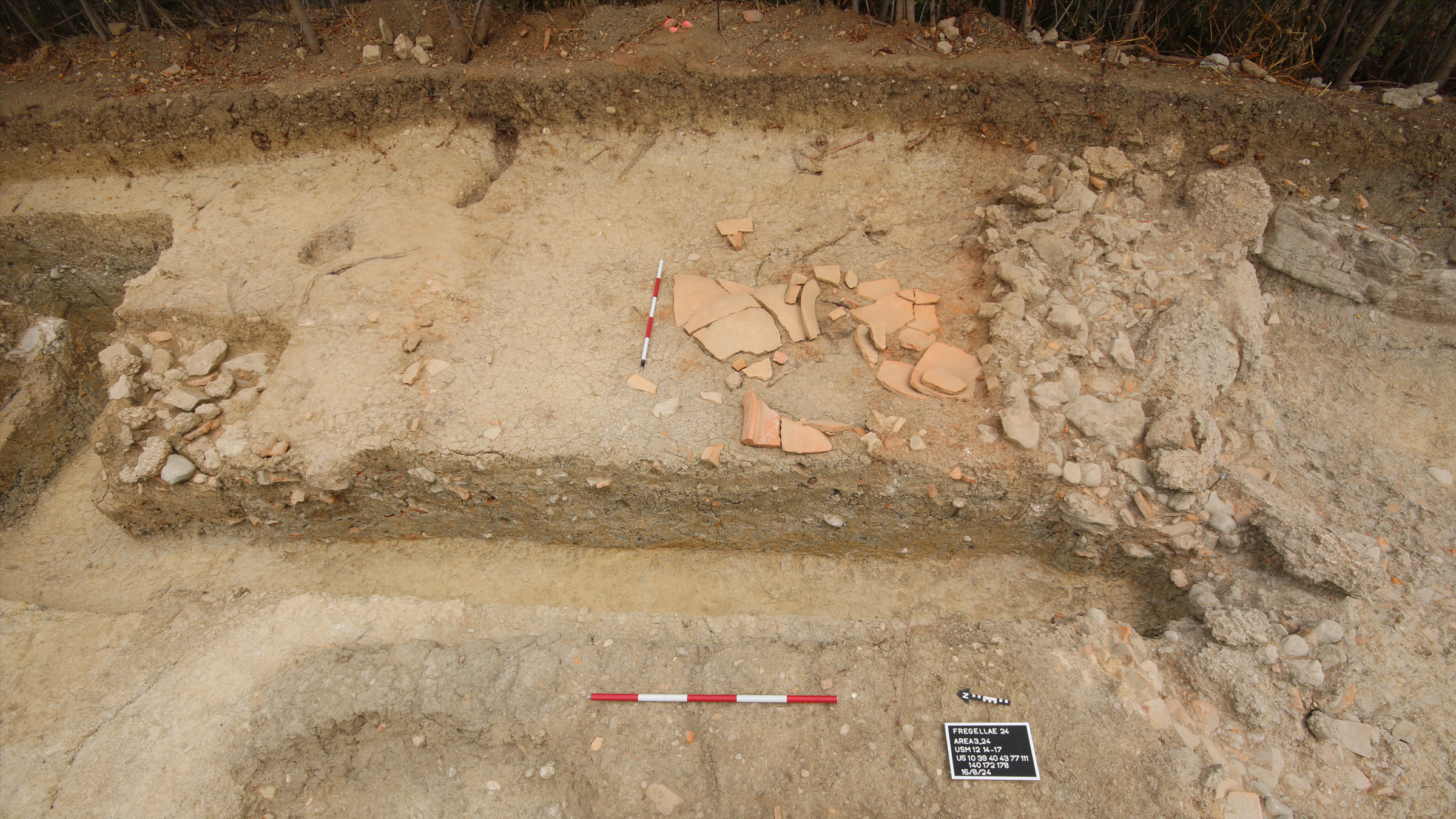 Shattered pottery on the dirt in a trench