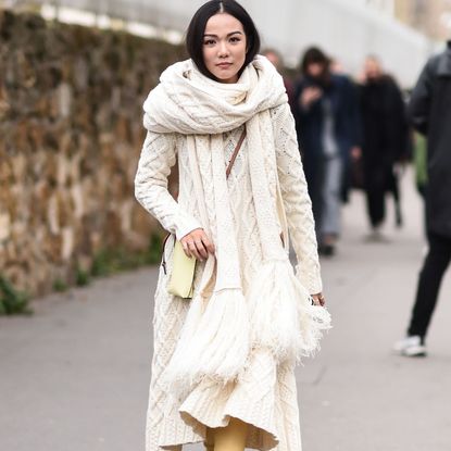 Fashion week attendee wears oversize cashmere scarf