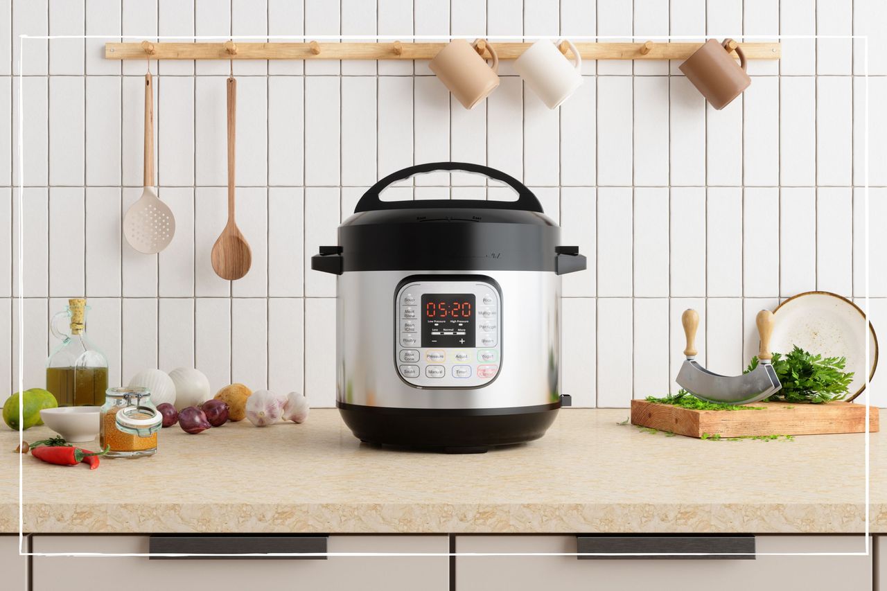 slow cooker on kitchen worktop surrounded by ingredients