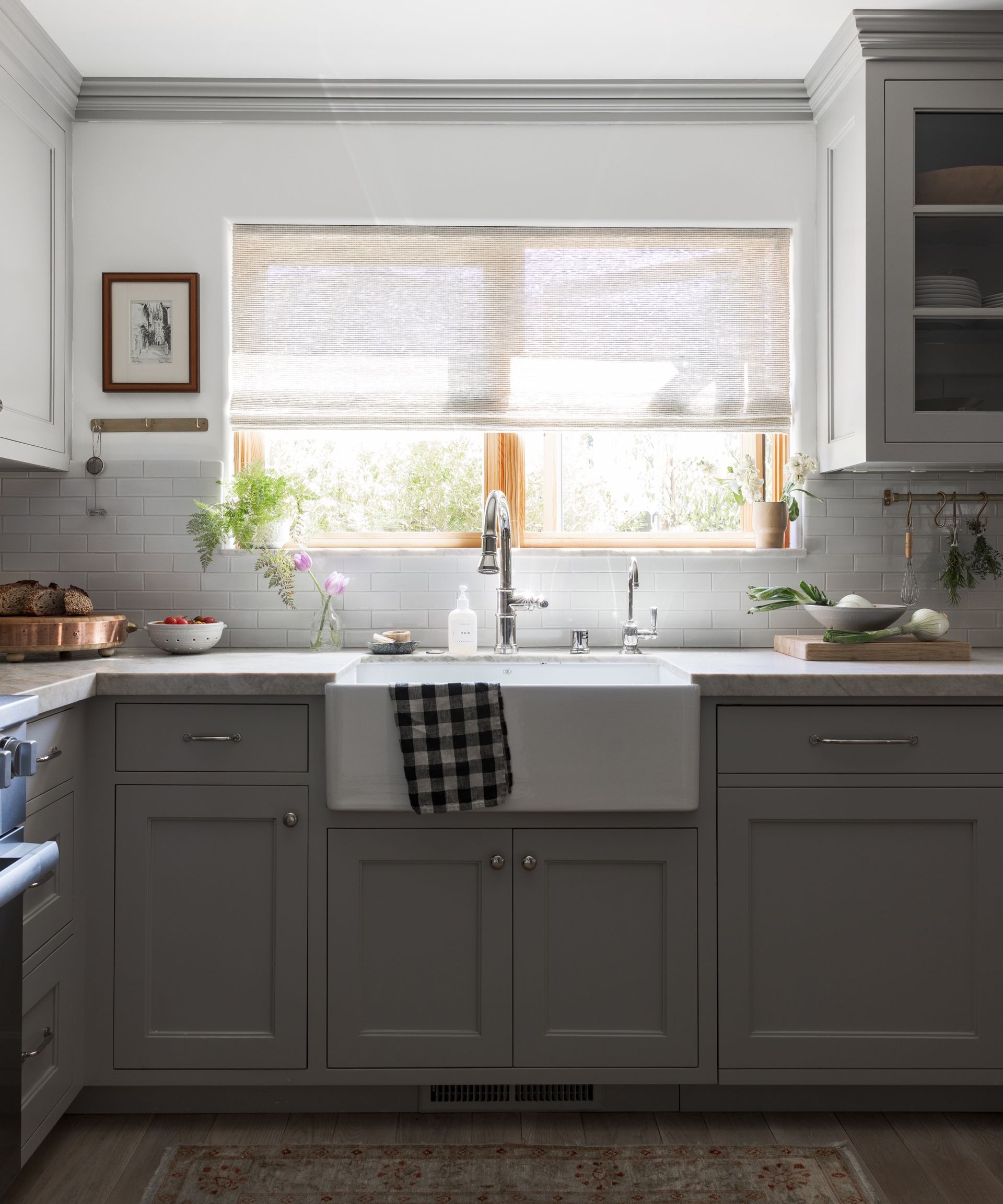 small grey kitchen with brass hooks by Innen Studio