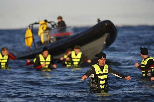 The Saxo Bank riders are dropped off in cold waters.