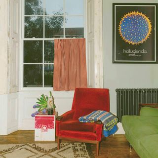 Living room with red armchair and colours of arley stripe cafe curtain