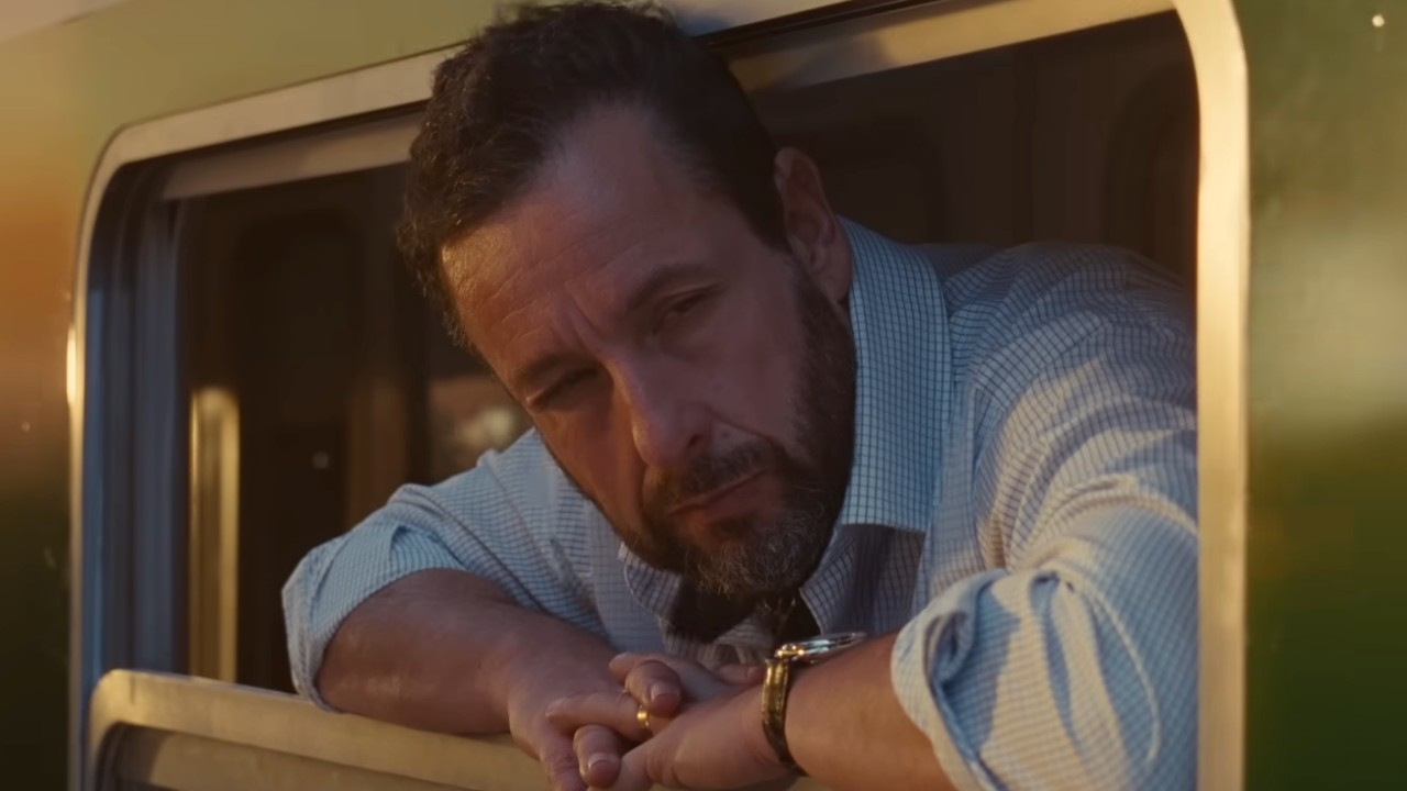 Ron Sukenick (Adam Sandler) looks out a window in Jay Kelly.