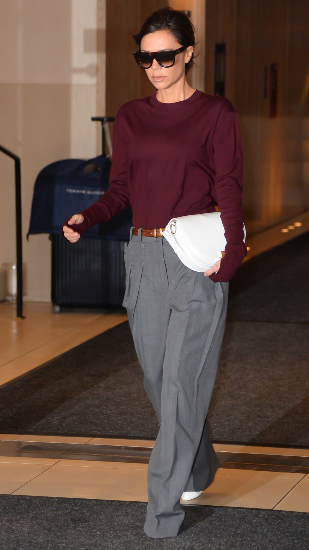 Victoria Beckham wearing burgundy top with grey suit trousers in New York City in 2017