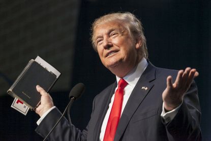 President Donald Trump holds his bible while speaking.