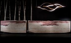 Henge kitchen against black background, with sculptural lighting