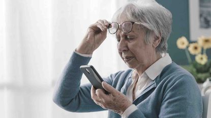Photo of older woman looking at her phone