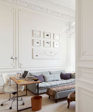 A Parisian apartment living room with walls covered in ornate paneling