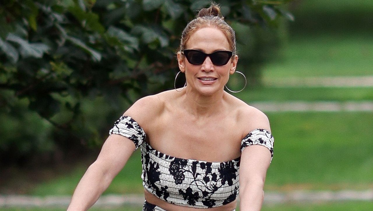 Jennifer Lopez bikes in a Hamptons floral skirt set and her new favorite shoe trend, the fisherman espadrille sandal, plus sunglasses