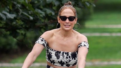 Jennifer Lopez bikes in a Hamptons floral skirt set and her new favorite shoe trend, the fisherman espadrille sandal, plus sunglasses