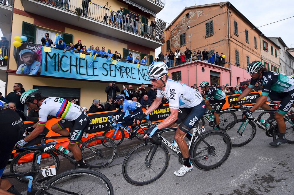 Peter Sagan passes a banner honouring Michele Scarponi