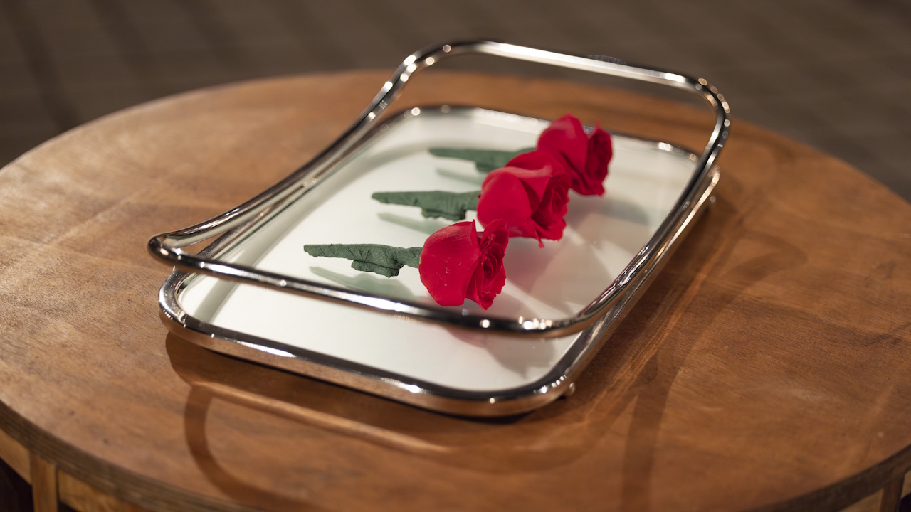 A tray of roses sits on a table on Bachelor in Paradise.