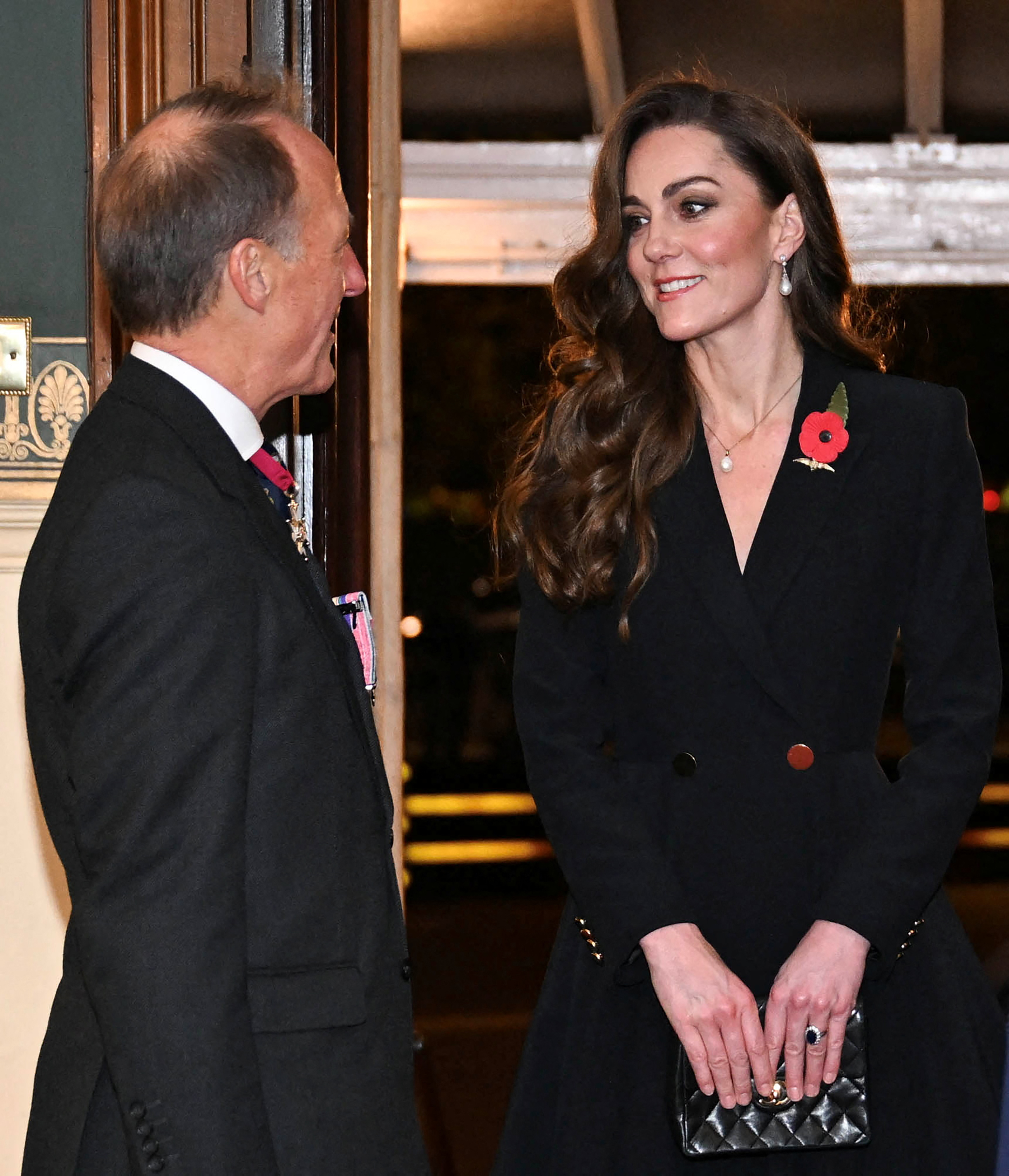 Princess Kate wearing a black blazer and poppy pin