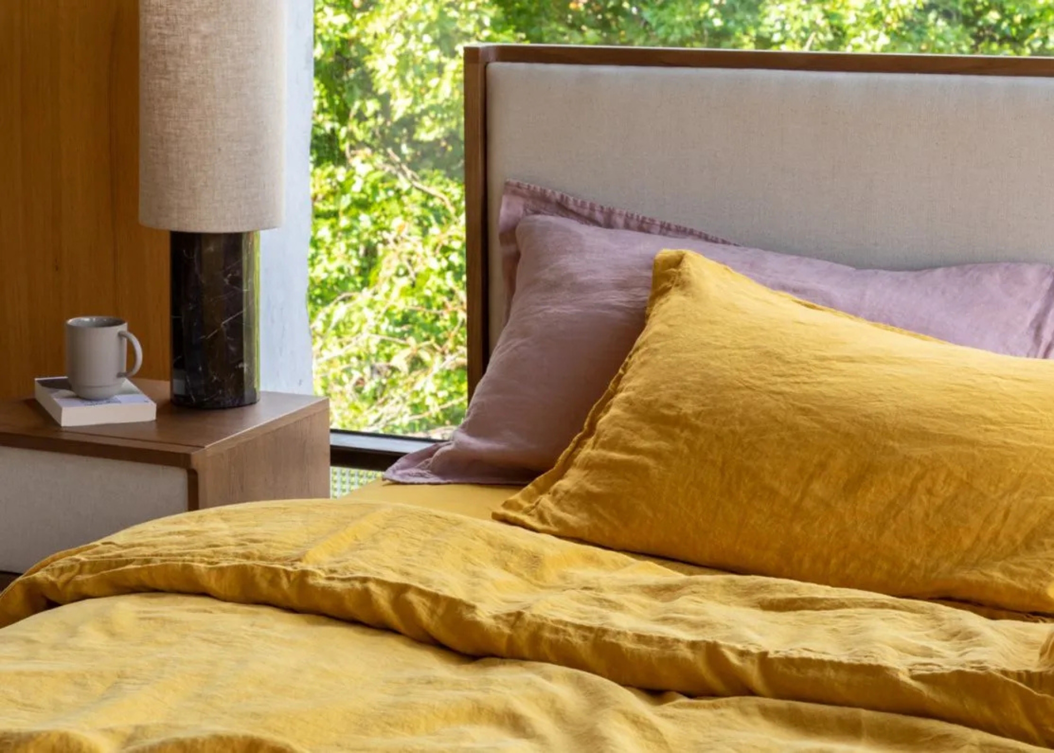 pink and yellow linen bedding on a bed