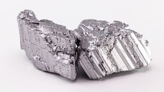 A silver-colored raw chunk of neodymium stone, part of the rare earth group, the world's strongest magnetic ore used in the technology industry.