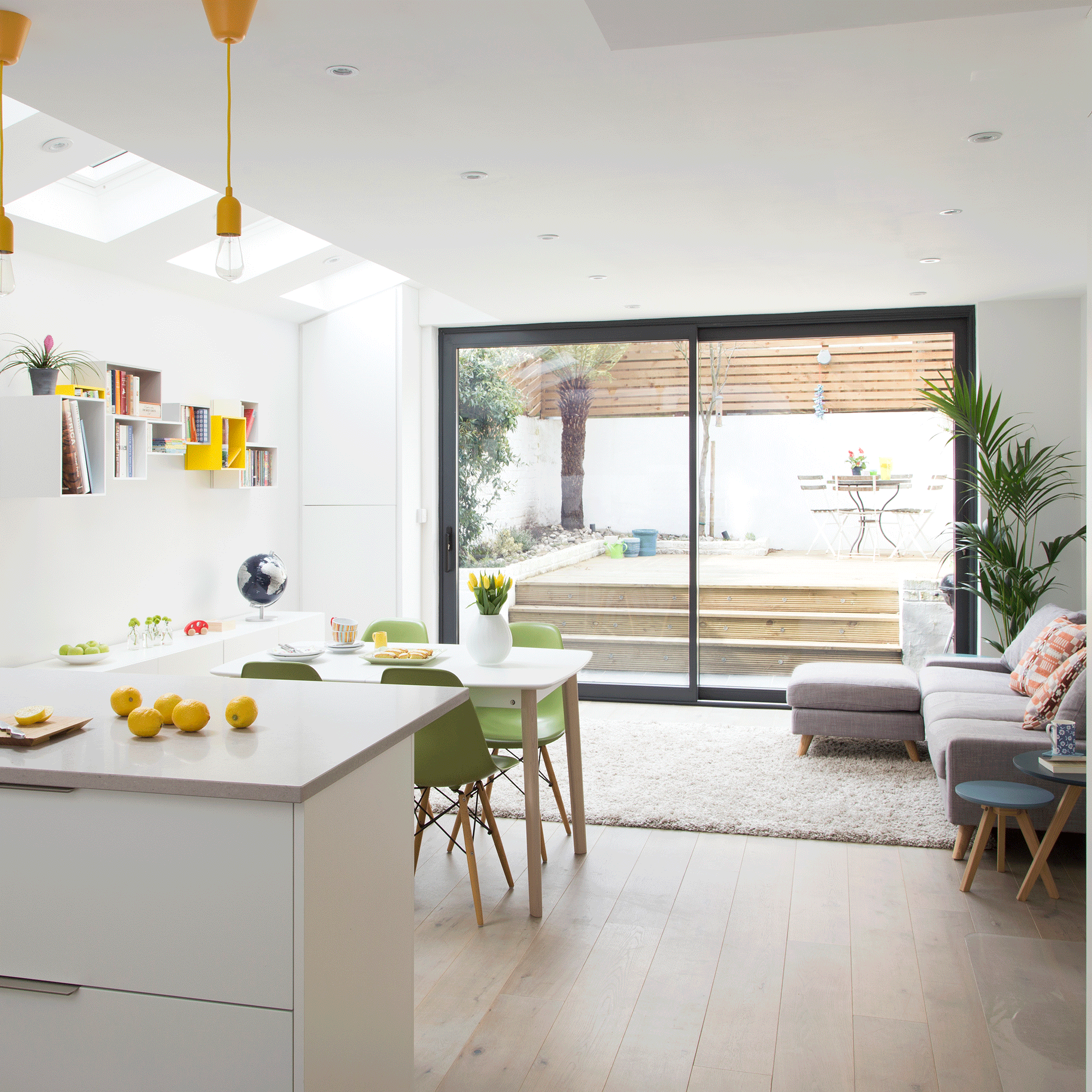 White kitchen with white island and sliding doors