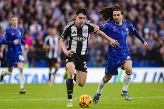 Tino Livramento of Newcastle and Marc Cucurella of Chelsea battle for the ball, October 2024.
