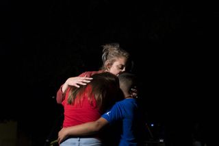 Texas School Shooting:A woman embraces two children outside Willie de Leon Civic Center in Uvalde, Texas, US, on Tuesday, May 24, 2022. President Joe Biden mourned the killing of at least 19 children and two teachers in a mass shooting at a Texas elementary school on Tuesday, decrying their deaths as senseless and demanding action to try to curb the violence. Photographer: Eric Thayer/Bloomberg via Getty Images