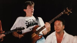 Bassist Derek Forbes and vocalist Jim Kerr of British rock band Simple Minds perform on stage at Wembley Arena on July 26th, 1989 in London, England