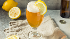 Shandy in a glass with a slice of lemon
