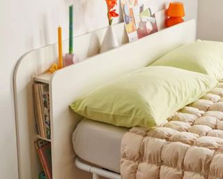 Urban Outfitters storage headboard in cool bedroom with green pillows