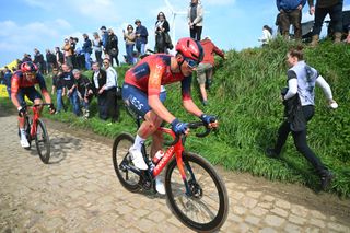Josh Tarling leads Ineos Grenadiers teammate Luke Rowe as they chase back from a crash at Paris-Roubaix