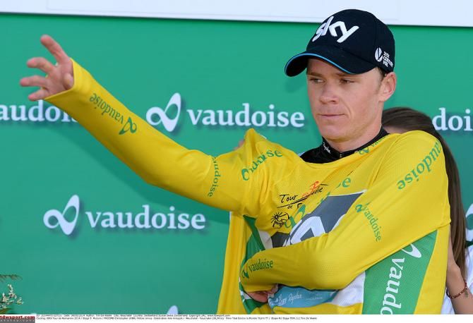 Chris Froome pulls on the yellow jersey
