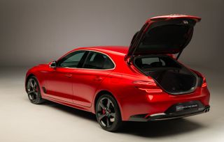 Rear view of the Genesis G70 Shooting Brake car in red with the boot open.