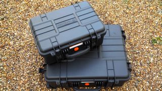 Vanguard Supreme hard cases on top of each other on a gravel surface