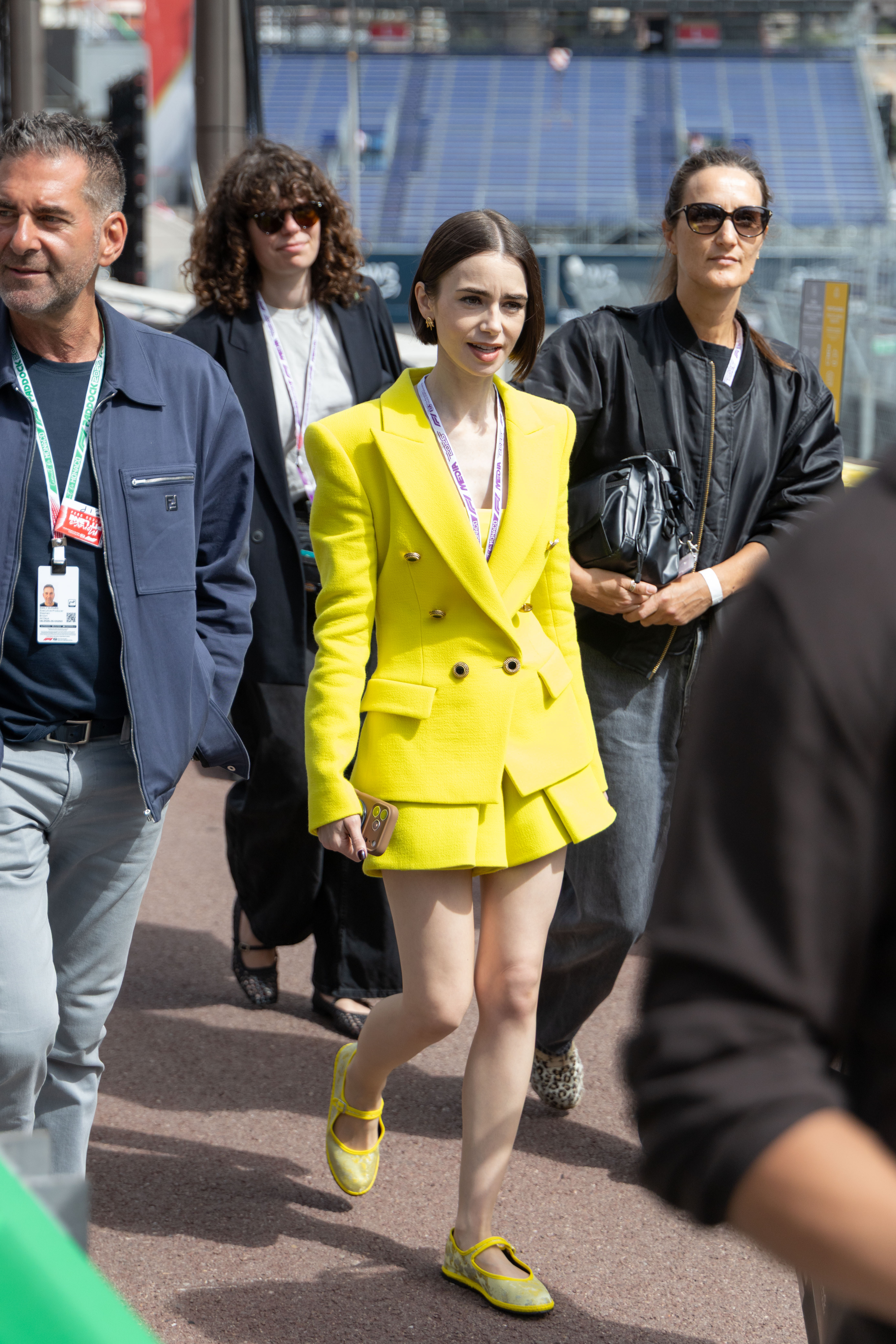 Lily Collins pulled off a neon green and purple color combination at the Formula 1 Monaco Grand Prix