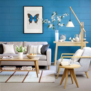 Blue living room with grey and pale wood furniture
