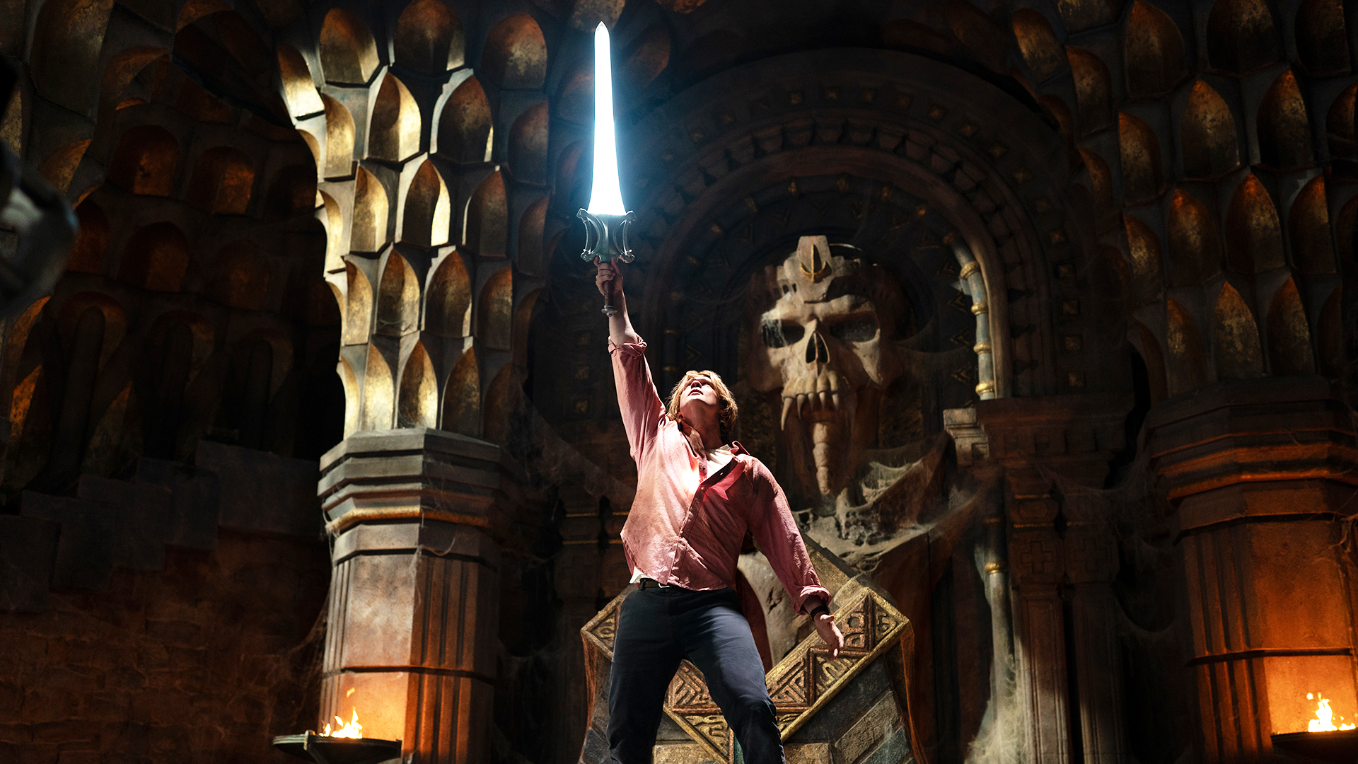 Adam holding the Sword of Power aloft in the bowels of Castle Grayskull in 2026's Masters of the Universe movie