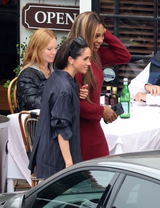 A photo of Serena Williams donning a long-sleeved burgundy sweater dress to meet Meghan Markle for Italian food in Montecito.