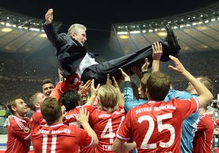 Bayern Munich coach Jupp Heynckes is thrown into the air by his players after the club's treble triumph in June 2013.