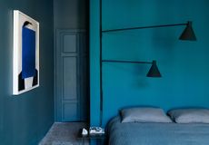 A bedroom with watery-blue walls