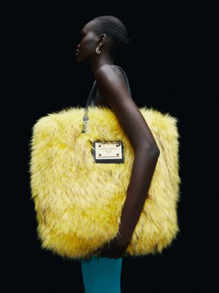 Woman with oversized faux fur yellow bag