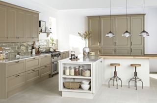 a greige and grey kitchen with a white island with breakfast bar