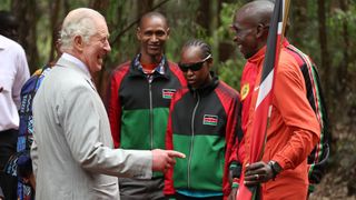 King Charles laughing and sharing a joke with Kenyan marathon runner Eliud Kipchoge