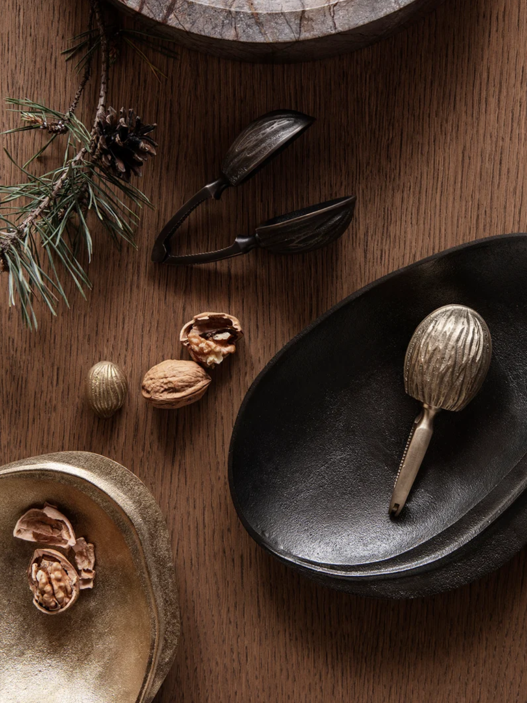 A gold and black nut cracker from Ferm Living