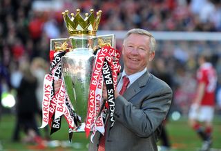 Sir Alex Ferguson lifts the 2010-11 Premier League trophy