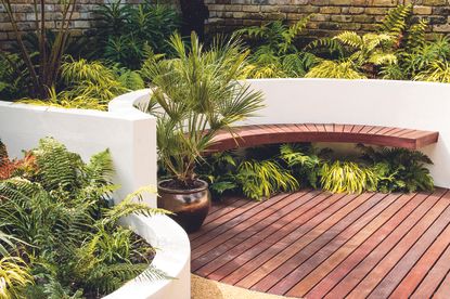 eco decking in a round patio with bench seating and tropical plants